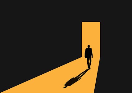 Image shows a man walking through a doorway. 