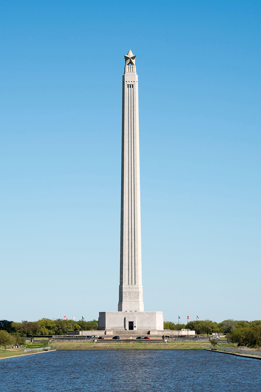 Photo shows a tall, pencil-like structure made of concrete. 