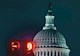 The domed U.S. Capitol building with traffic lights displaying red in the foreground