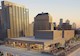 aerial image shows mechanical areas on the roof of a building with a skyline of buildings in the background