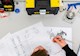 overhead shot of a person at a desk with surrounded by engineering tools of the trade