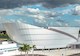 Aerial view of Mote Science Education Aquarium beside water, parking lot, dramatic clouds
