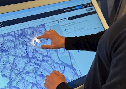 a person operates touchscreen featuring a map